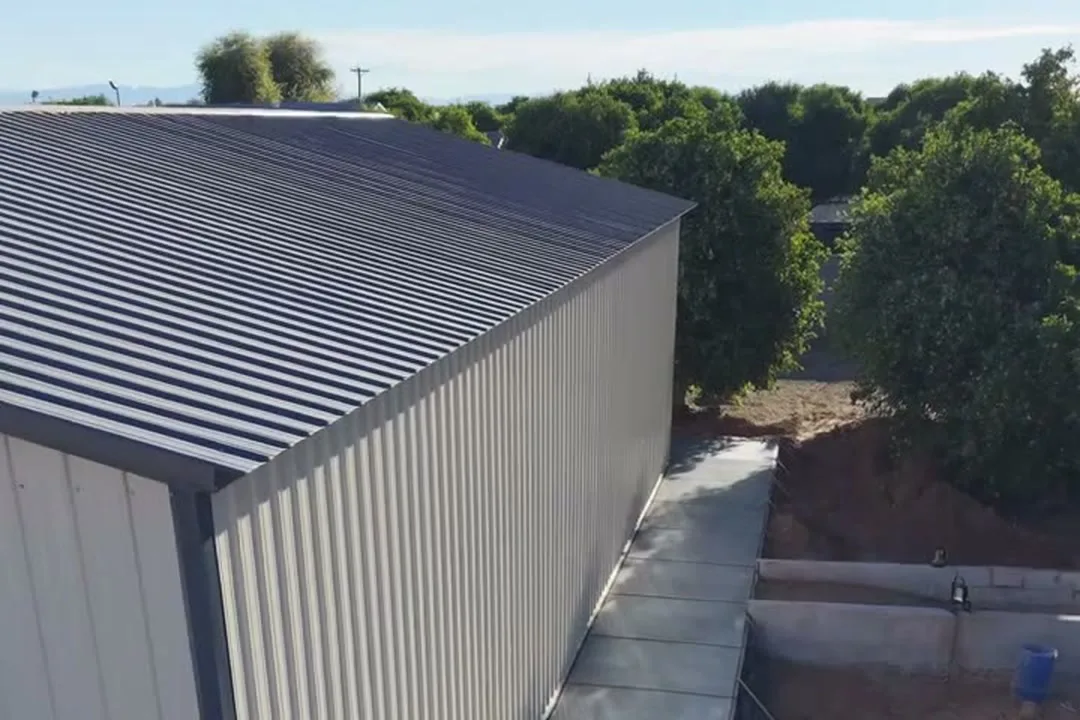 Concrete slab and apron poured along the wall of a metal building